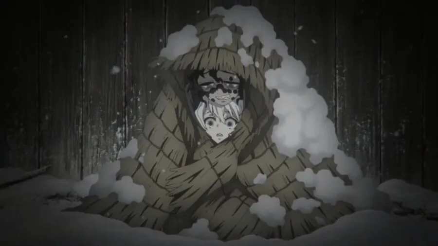 "Demon Slayer: Entertainment District Arc" Ep. 11 "No Matter How Many Lives" screenshot showing Gyutaro and Ume huddling together in the snow under some straw mats.