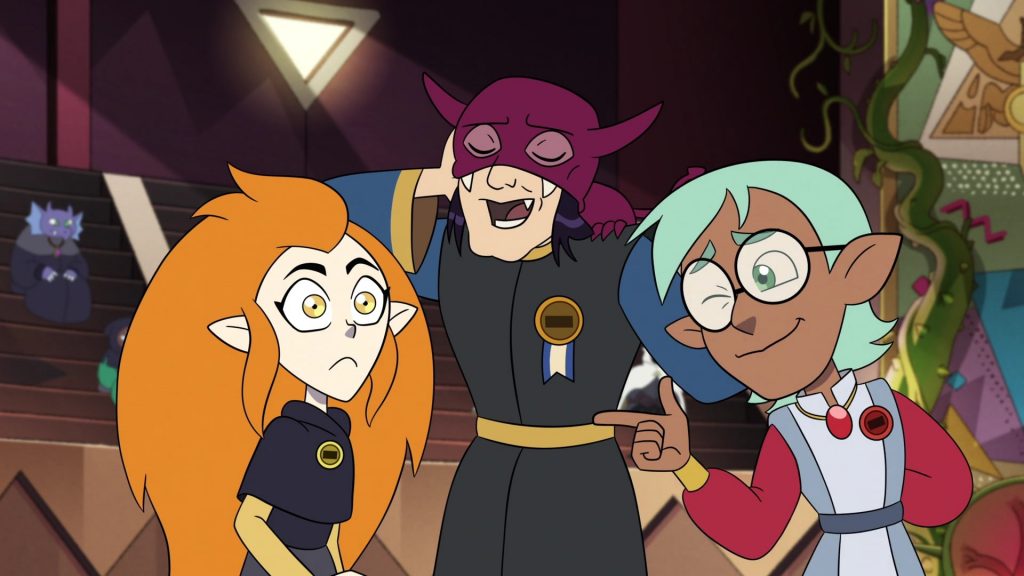 "The Owl House Season 2 Ep. 15 "Them's the Breaks, Kid"" screenshot showing a young Raine making a finger gun at young Eda, with a young Principal Bump laughing(?) in the background.