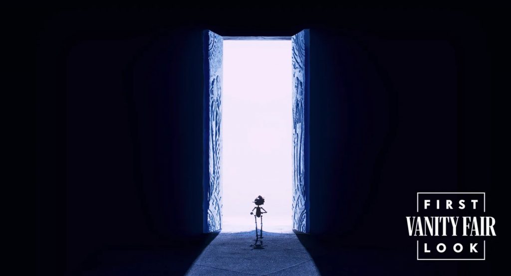 "Guillermo del Toro's Pinocchio" first look image 7, showing Pinocchio walking into a creepy open set of doors into the light.