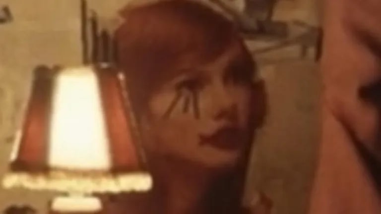 "Cruella" Screenshot showing the female character (with eyeliner/face paint oozing from her right eye) rumored to be played by Taylor Swift.