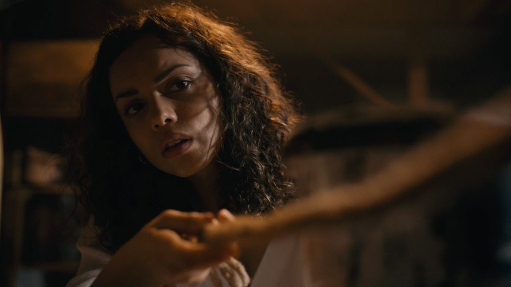 Tess (Georgina Campbell) pulls a rope opening a secret basement tunnel in 'Barbarian'