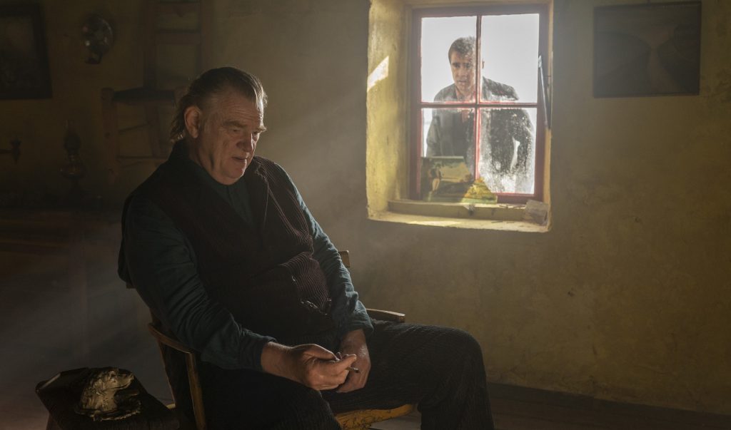 Colm (Brendan Gleeson) sits inside his home as Padraic (Colin Farrell) looks in through the window