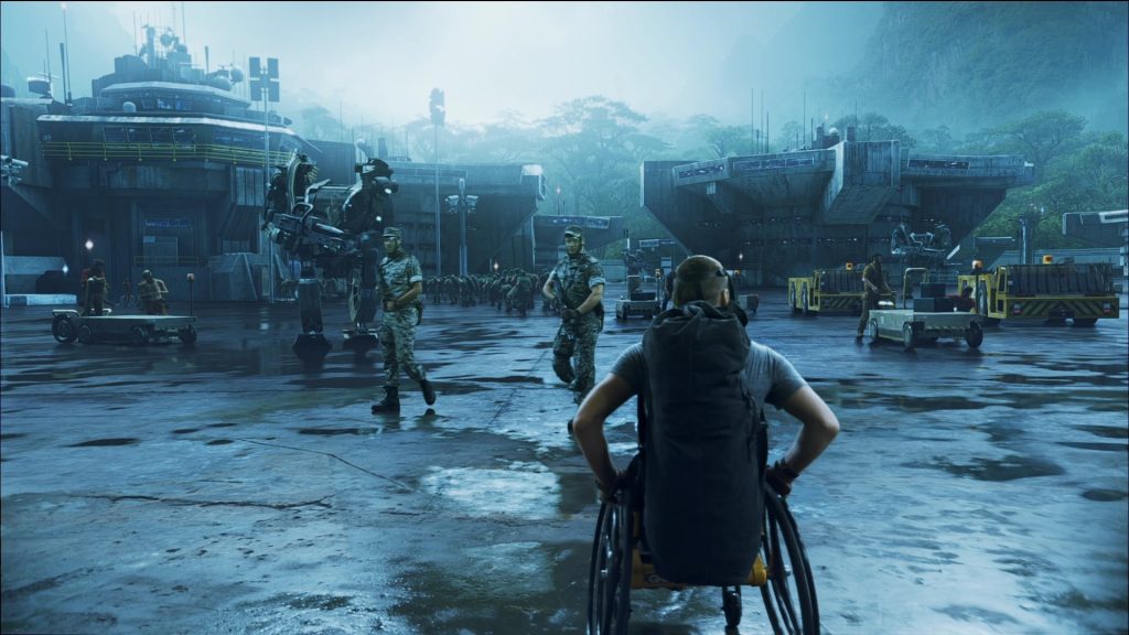 "Avatar" screenshot showing Jake Sully rolling towards the interior of Hell's Gate base in his wheelchair.
