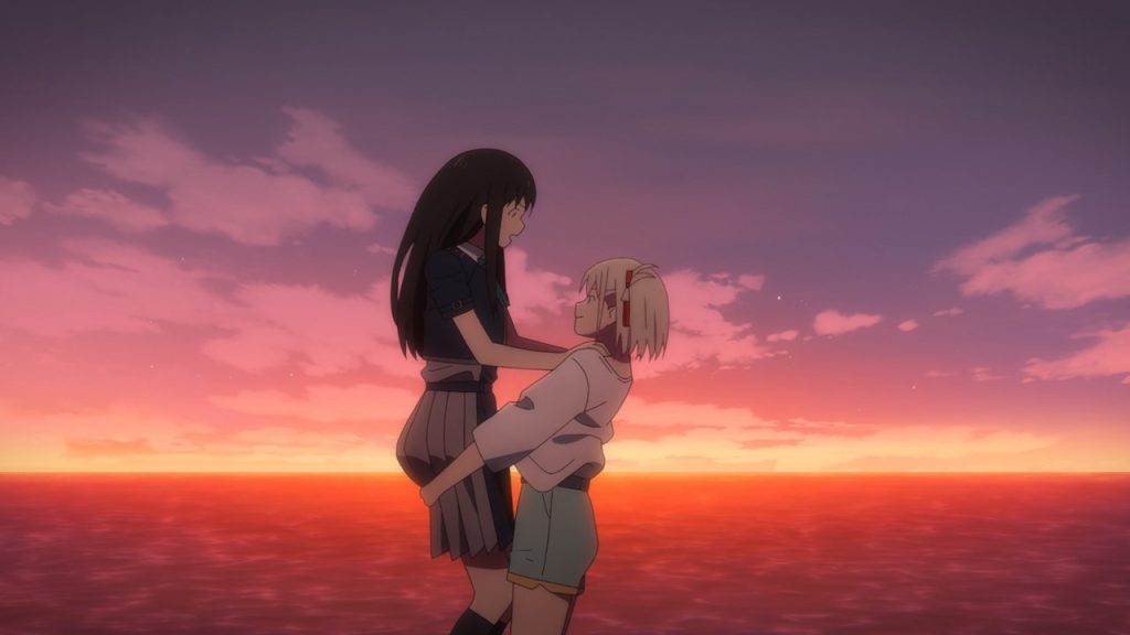 'Lycoris Recoil' anime screenshot showing Chisato holding up Takina against the backdrop of a beautiful sunset in the colors of the lesbian flag.