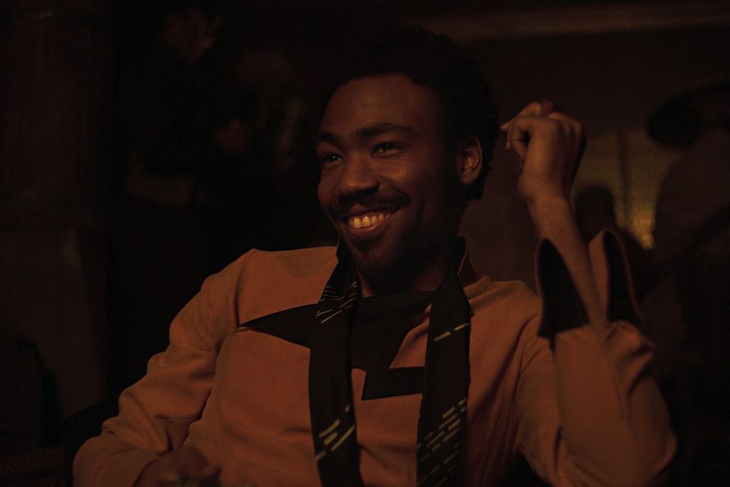 'Solo: A Star Wars Story' screenshot depicting a grinning Lando Calrissian (played by Donald Glover) upon first meeting a young Han Solo.