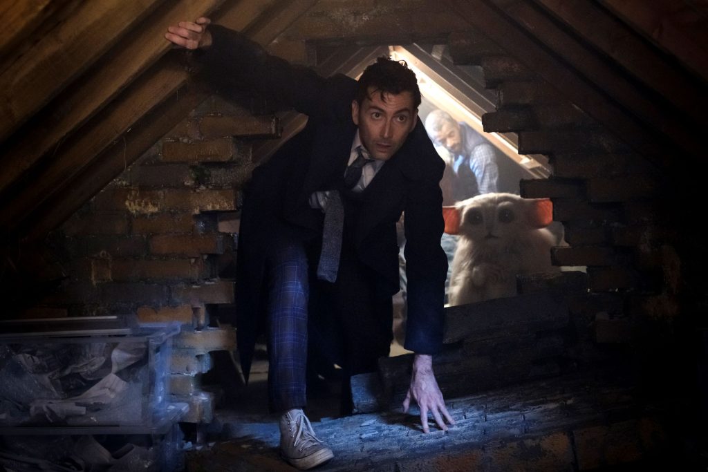 David Tennant's Doctor climbs through an attic alongside the Meep in "The Star Beast"