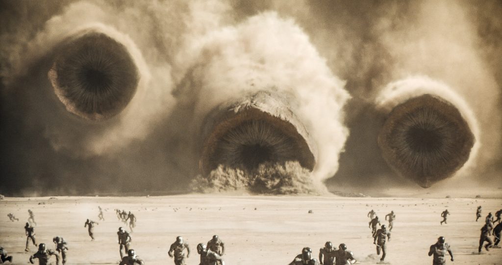 Dune: Part Two official trailer 3 image featuring the sandworms heading right for a Harkonnen army.
