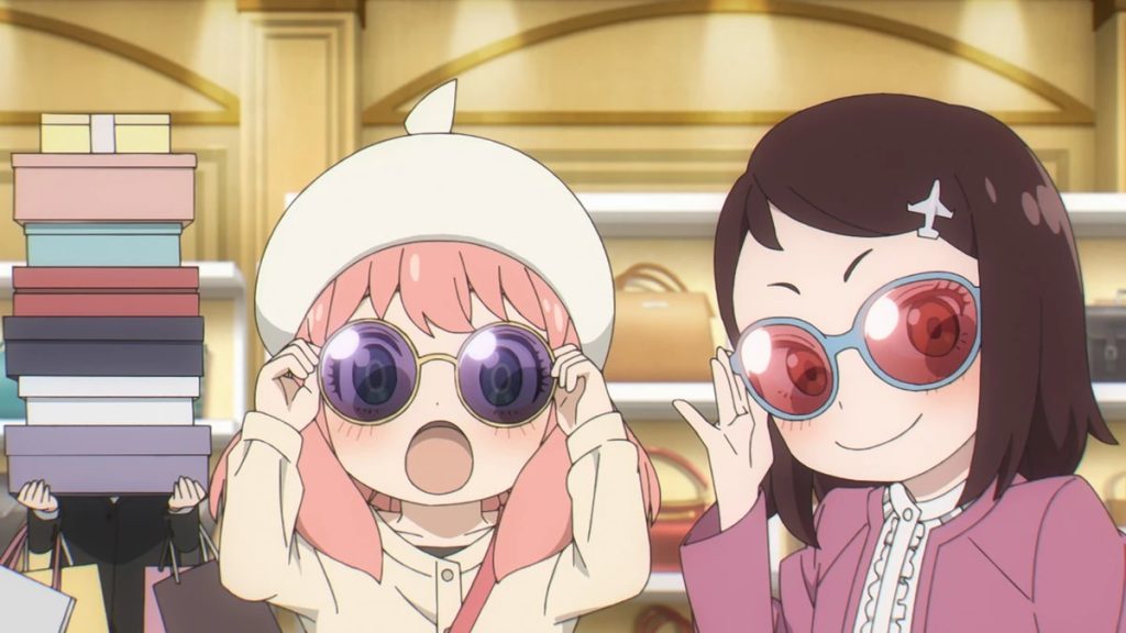 Spy x Family anime screenshot showing Anya and Becky trying on sunglasses, with Martha carrying the groceries in the background.