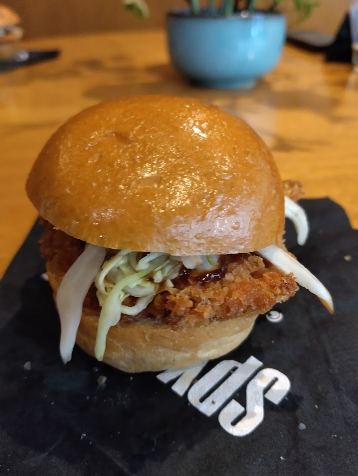 Chicken katsu slider with lettuce and sweet sauce.