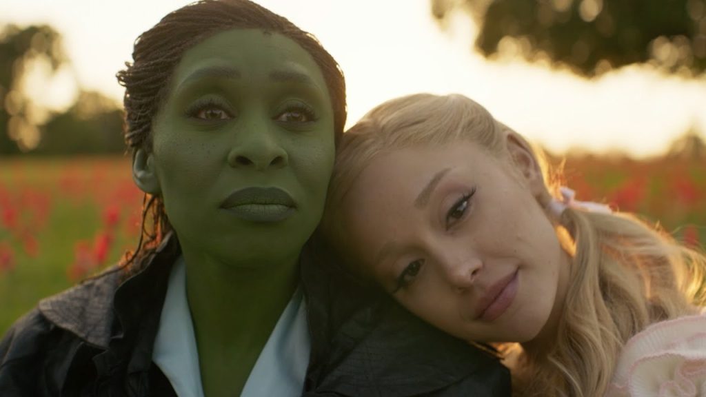 Glinda (Ariana Grande) rests her head on Elphaba's (Cynthia Erivo) shoulder in Wicked