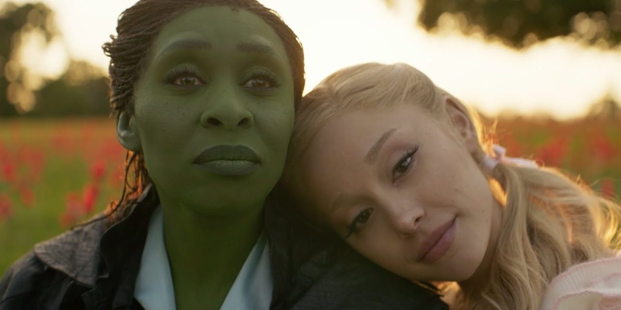 Glinda (Ariana Grande) rests her head on Elphaba's (Cynthia Erivo) shoulder in Wicked