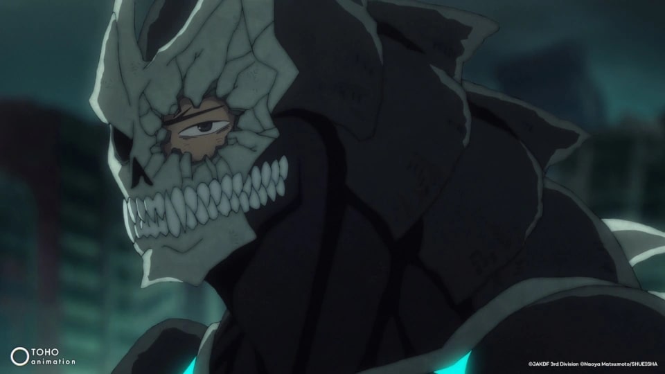 Kaiju No. 8 Ep. 10 "Secret Revealed" showing Kafka's kaiju exoskeleton skull falling apart, revealing his sad eye.