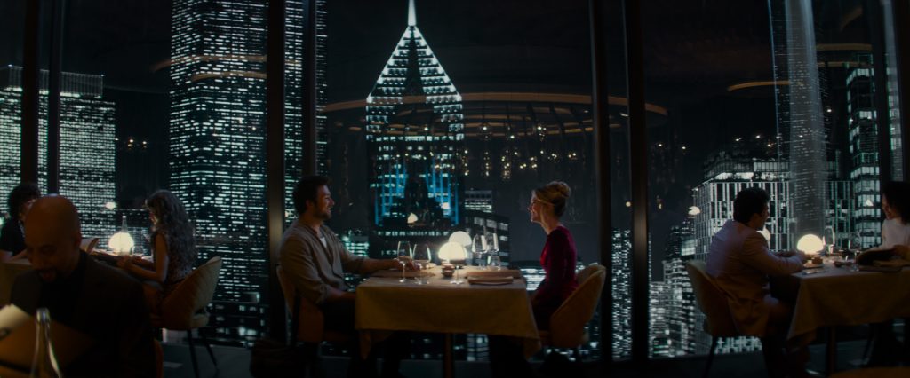 Henry (Brandon Sklenar) and Violet (Meghann Fahy) seated at a restaurant table in Drop